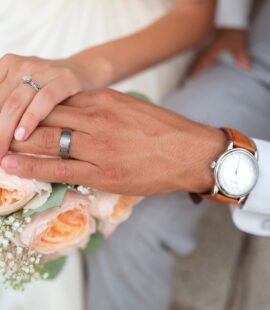 What is a Premarital Agreement, two people holding hands with wedding rings